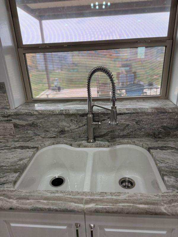A beautiful new sink with a brand new garbage disposal.