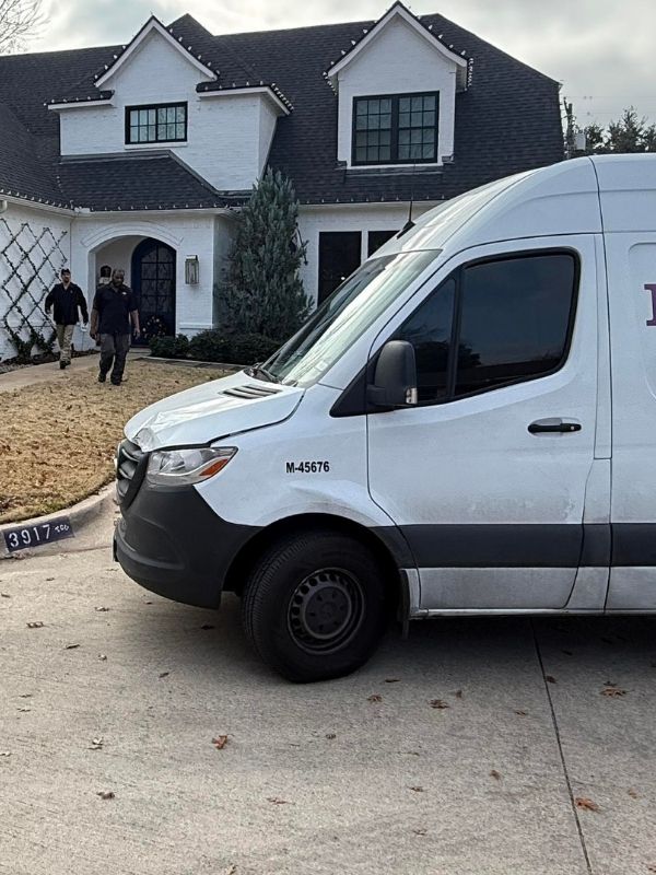 A picture of North Texas Plumbers and their work truck in front of a house.