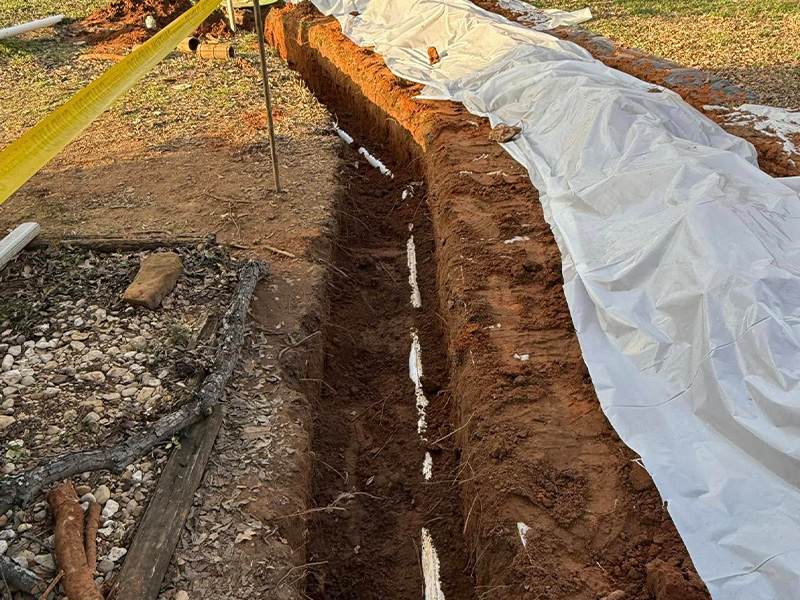 a trench with pvc pipe in it