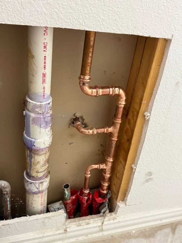 A copper pipe in a wall. 